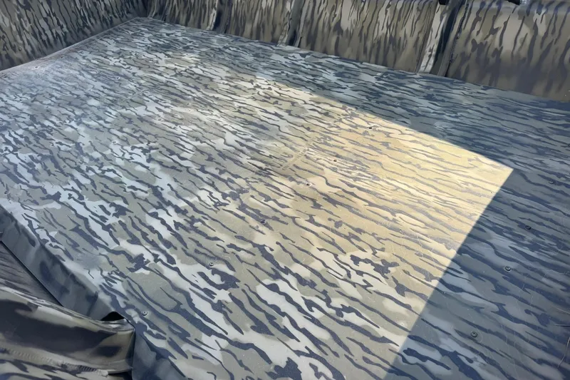 Slide: The Image of 2025 SeaArk 1648 MV Special boat interior with camouflage pattern flooring. - 20