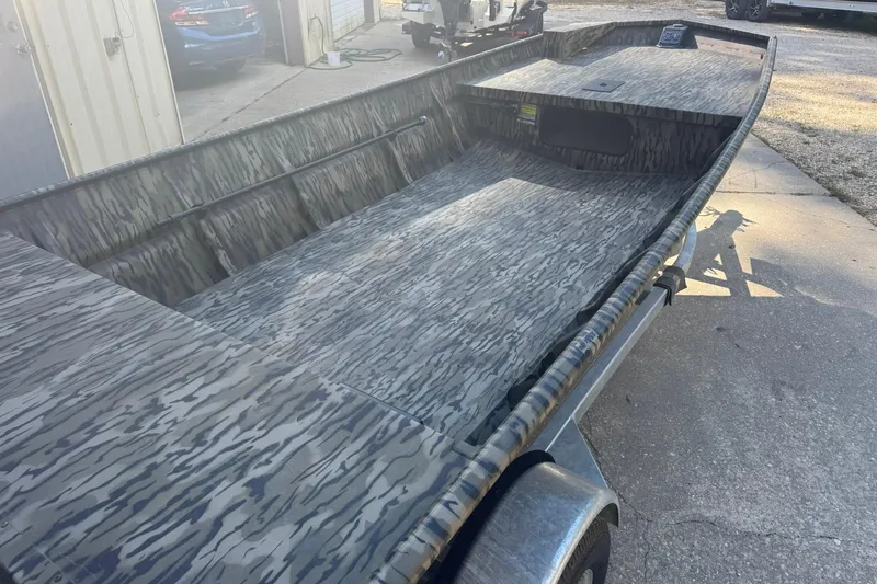 Slide: The Image of 2025 SeaArk 1648 MV Special boat with camouflage interior, parked on a trailer. - 3