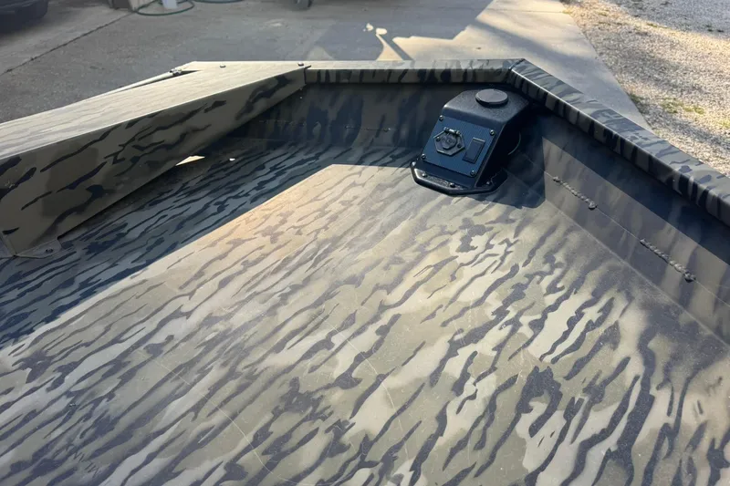 Slide: The Image of 2025 SeaArk 1648 MV Special boat interior with camouflage pattern and mounted control panel. - 5