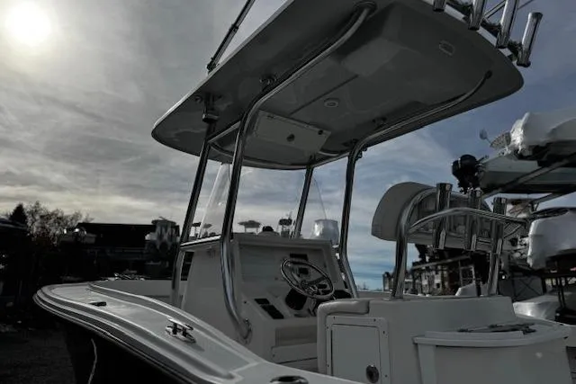 Slide: The Image of 2022 NorthCoast 230 Center Console boat under a cloudy sky, showcasing helm and seating area. - 1