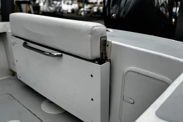 Slide: The Image of 2022 NorthCoast 230 Center Console boat interior with cushioned seating and storage compartment. - 11