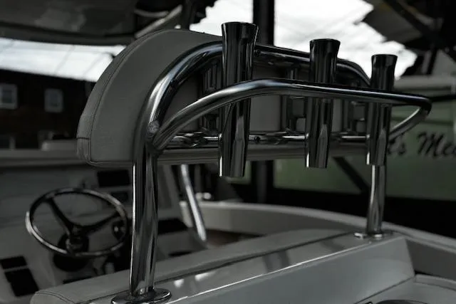 Slide: The Image of 2022 NorthCoast 230 Center Console boat with stainless steel rod holders and steering wheel. - 13