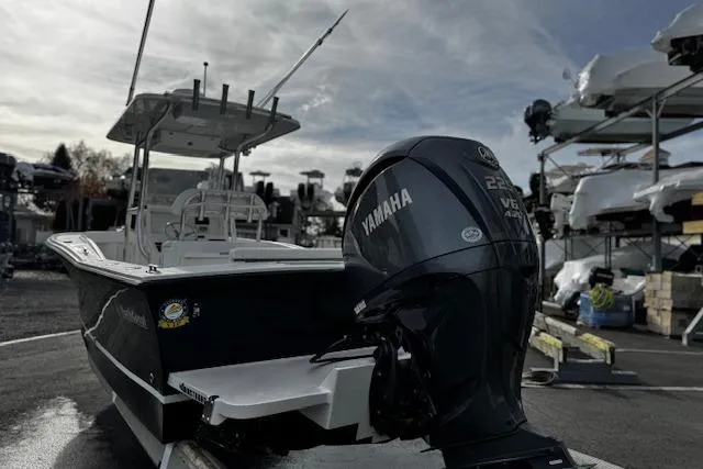 Slide: The Image of 2022 NorthCoast 230 Center Console boat with Yamaha engine, docked outdoors. - 2