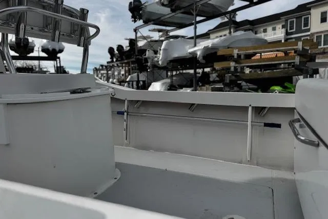 Slide: The Image of 2022 NorthCoast 230 Center Console boat interior with docked vessels in background. - 4