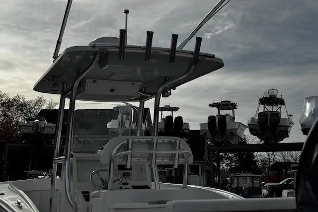 Slide: The Image of 2022 NorthCoast 230 Center Console boat in a marina, under a cloudy sky. - 7