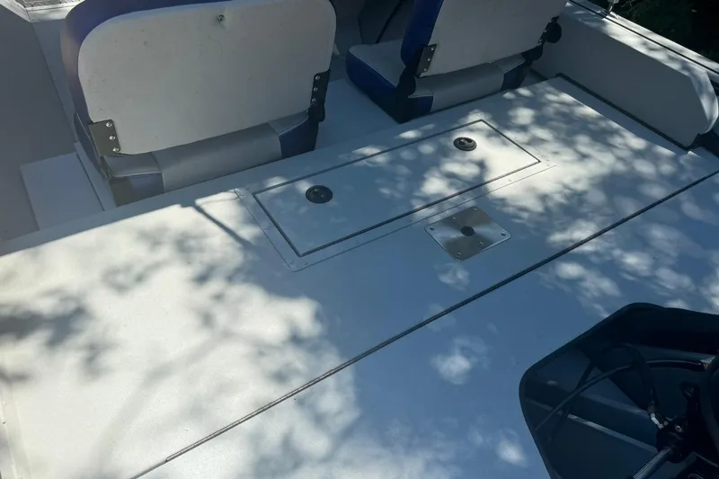 Slide: The Image of 2024 SeaArk Shadow 20 boat interior with seating and storage compartments. - 13