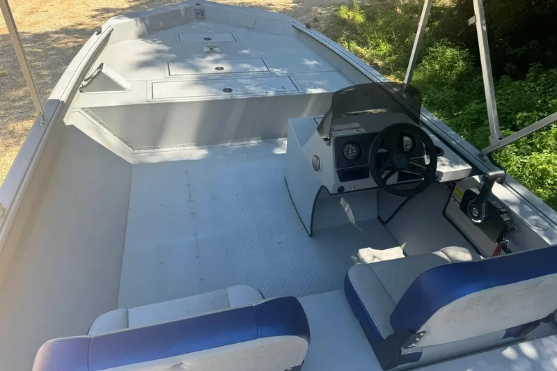 Slide: The Image of 2024 SeaArk Shadow 20 boat interior with steering console and seating. - 14