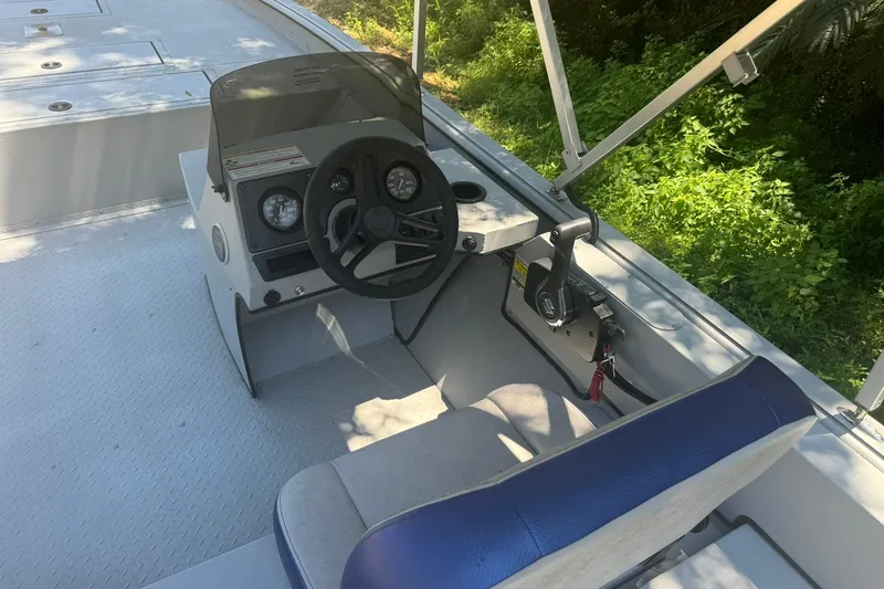 Slide: The Image of 2024 SeaArk Shadow 20 boat interior with steering wheel and control panel. - 15