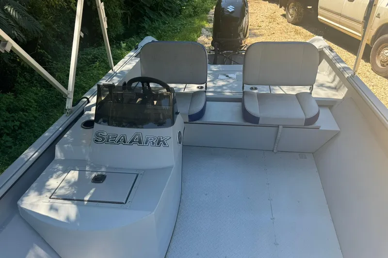 Slide: The Image of 2024 SeaArk Shadow 20 boat interior with seating and steering console. - 17