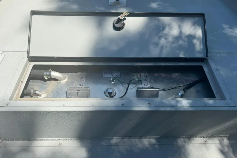 Slide: The Image of Open compartment of 2024 SeaArk Shadow 20 boat showing internal components and wiring. - 19