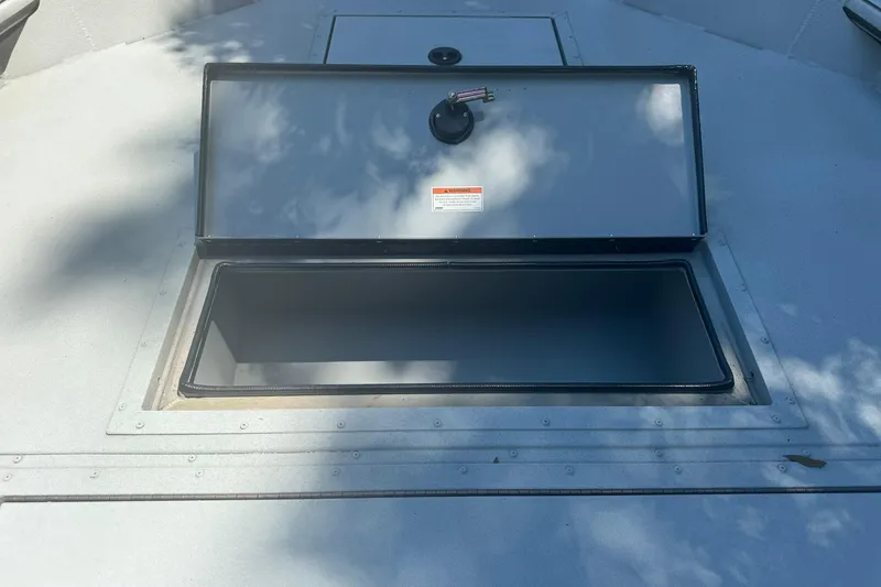 Slide: The Image of Open storage compartment on 2024 SeaArk Shadow 20 boat, showing interior space. - 20