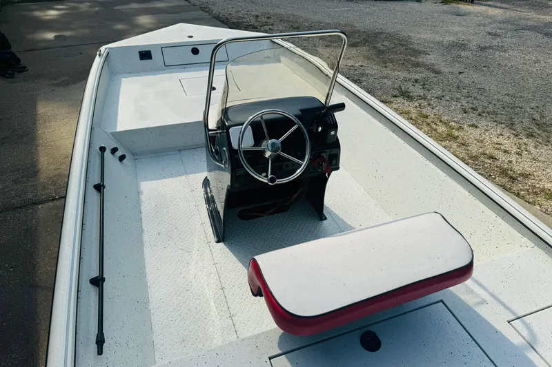 Slide: The Image of 2024 SeaArk Shadow 19 v boat interior with steering console and seating. - 18