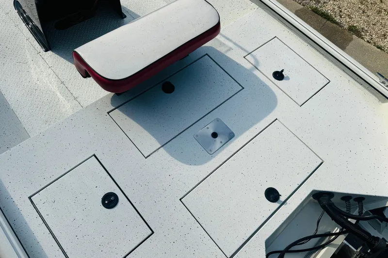 Slide: The Image of 2024 SeaArk Shadow 19 v boat deck with storage compartments and seating. - 19