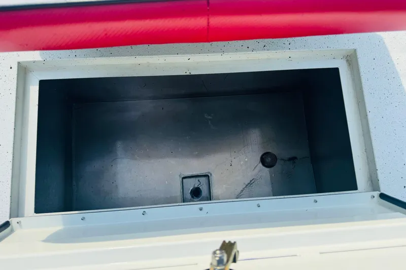 Slide: The Image of Open storage compartment in 2024 SeaArk Shadow 19 v boat, featuring a clean, spacious interior. - 20