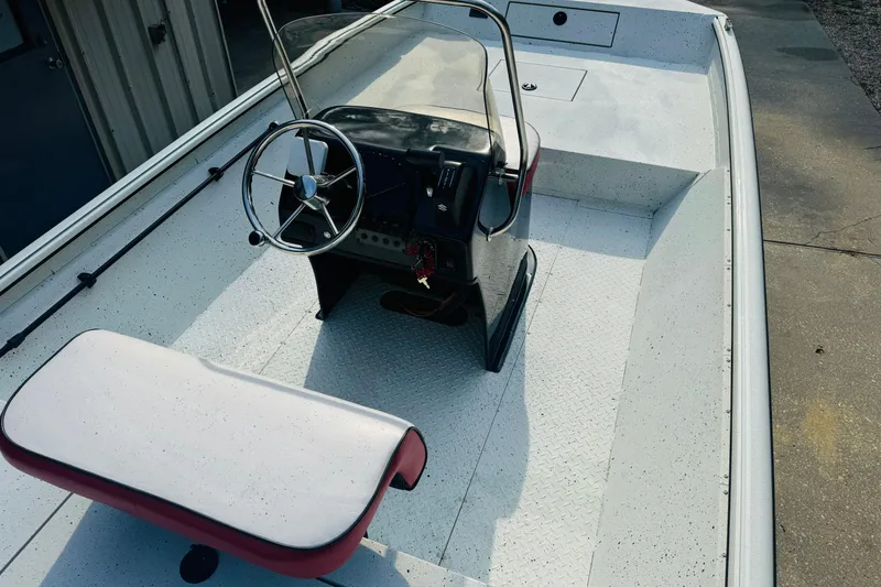 Slide: The Image of 2024 SeaArk Shadow 19 v boat interior with steering console and seating. - 21