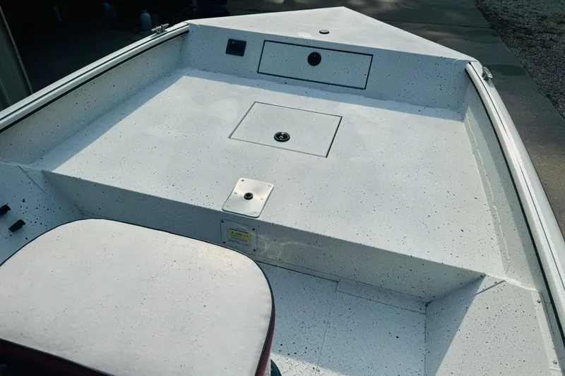 Slide: The Image of 2024 SeaArk Shadow 19 v boat deck with storage compartments. - 22