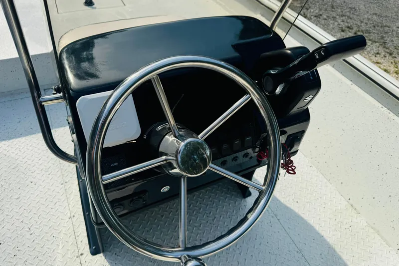 Slide: The Image of Steering console of 2024 SeaArk Shadow 19 v boat with chrome wheel and controls. - 25