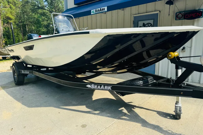 Slide: The Image of 2024 SeaArk Shadow 19 v boat on trailer, parked outside a building. - 3