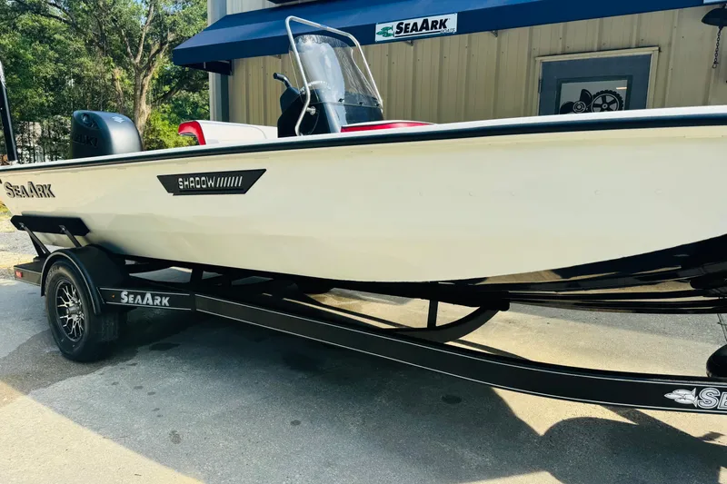 Slide: The Image of 2024 SeaArk Shadow 19 v boat on trailer, parked outside a building. - 4