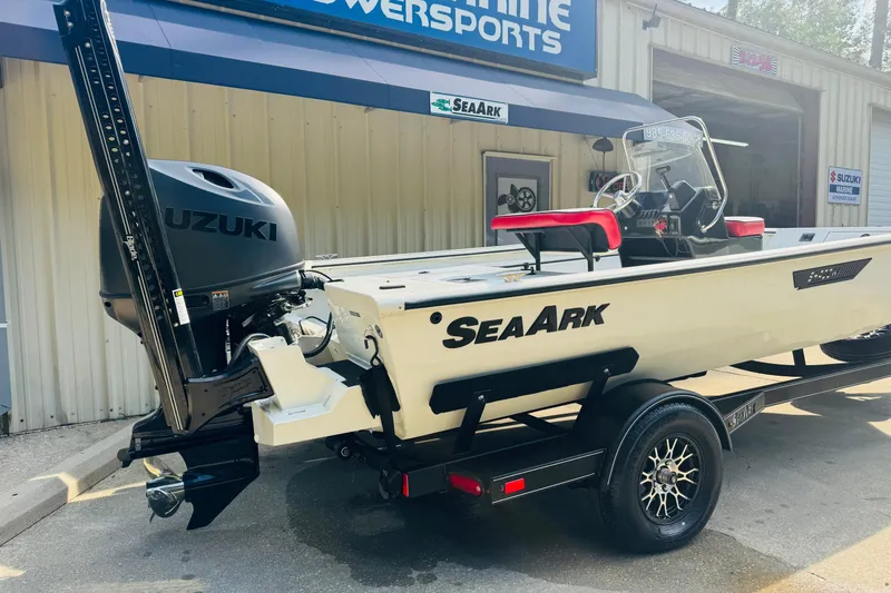 Slide: The Image of 2024 SeaArk Shadow 19 v boat with Suzuki engine at a marine dealership. - 6