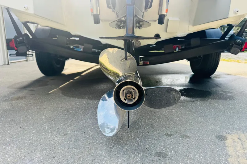 Slide: The Image of 2024 SeaArk Shadow 19 v boat propeller and trailer on pavement. - 7