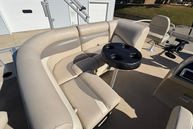 Slide: The Image of 2014 Godfrey Sweetwater 2086 F pontoon boat interior with beige seating and cup holder table. - 15
