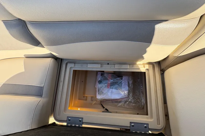 Slide: The Image of Storage compartment in 2014 Godfrey Sweetwater 2086 F boat, beige seating. - 17