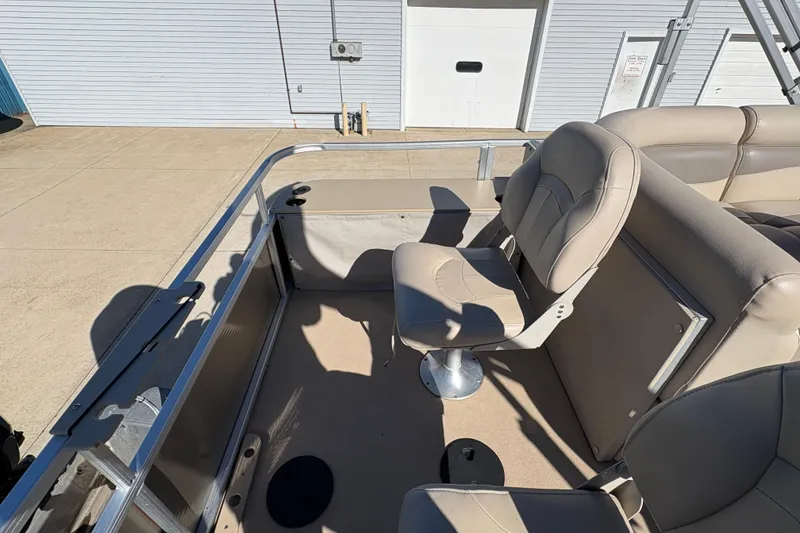 Slide: The Image of 2014 Godfrey Sweetwater 2086 F boat interior with beige seating and metal railing. - 21