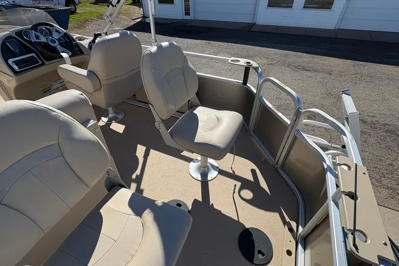 Slide: The Image of 2014 Godfrey Sweetwater 2086 F boat interior with beige seating and steering console. - 24