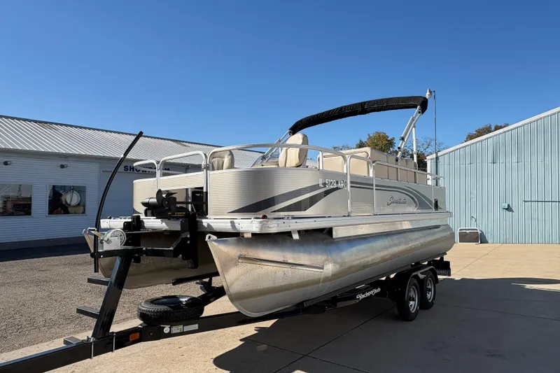 Slide: The Image of 2014 Godfrey Sweetwater 2086 F pontoon boat on trailer, parked outside a building. - 5