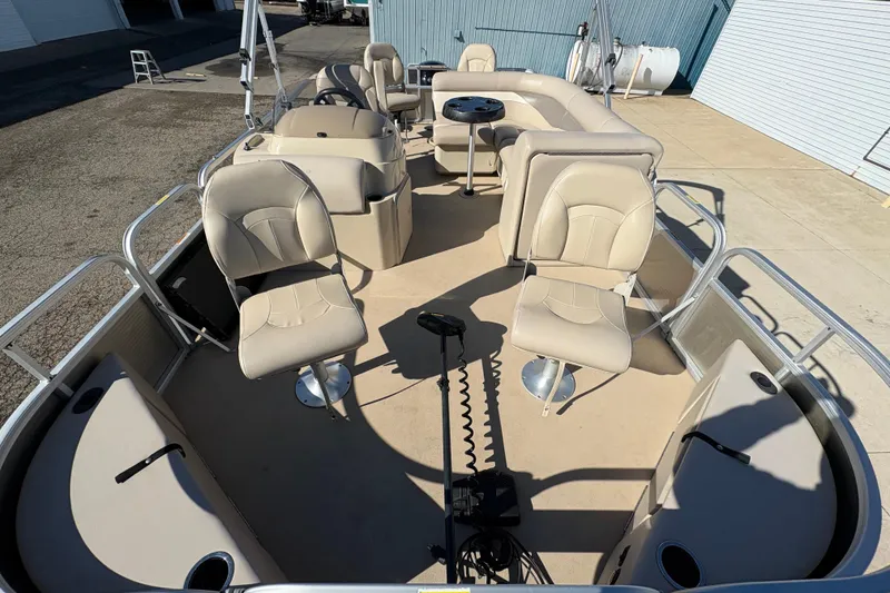Slide: The Image of 2014 Godfrey Sweetwater 2086 F pontoon boat interior with beige seating and fishing chairs. - 8