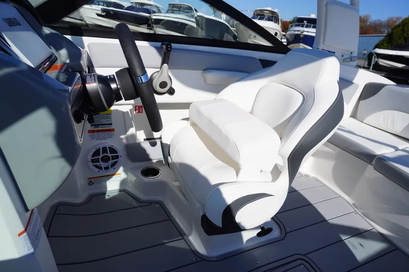 Slide: The Image of Interior of 2026 Chaparral 21 SSi OB boat with white seating and steering wheel. - 20