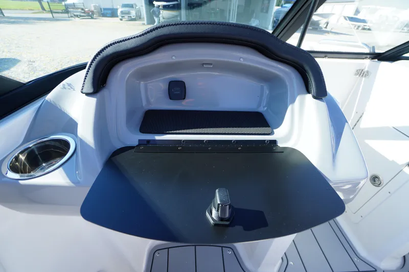 Slide: The Image of 2026 Chaparral 21 SSi OB boat interior with storage compartment and cup holder. - 23