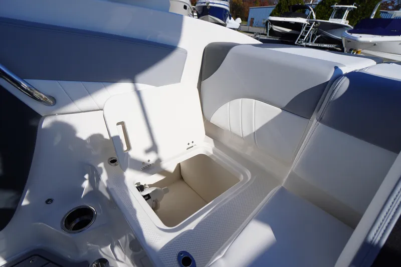 Slide: The Image of Interior view of 2026 Chaparral 21 SSi OB boat, featuring storage compartment and seating. - 39