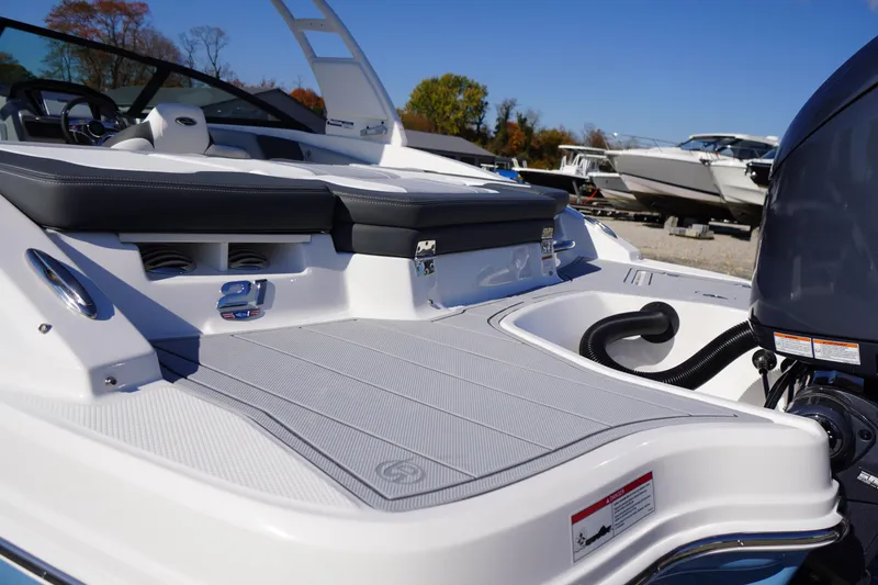 Slide: The Image of 2026 Chaparral 21 SSi OB boat, rear deck view with seating and engine details. - 46