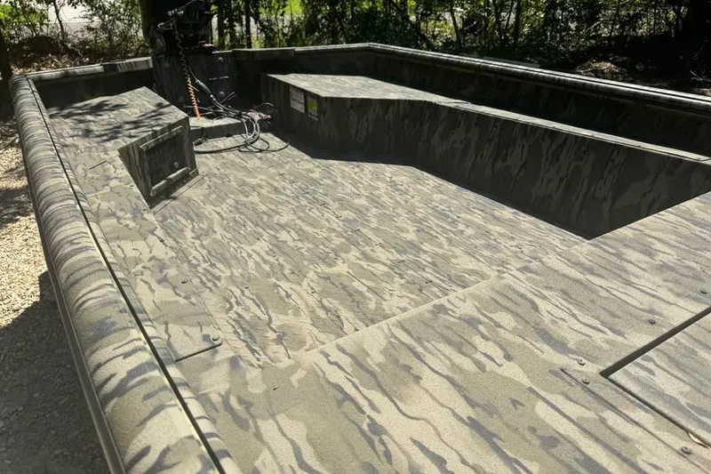 Slide: The Image of 2025 SeaArk 1752 Slayer Pro boat with camouflage interior design. - 11