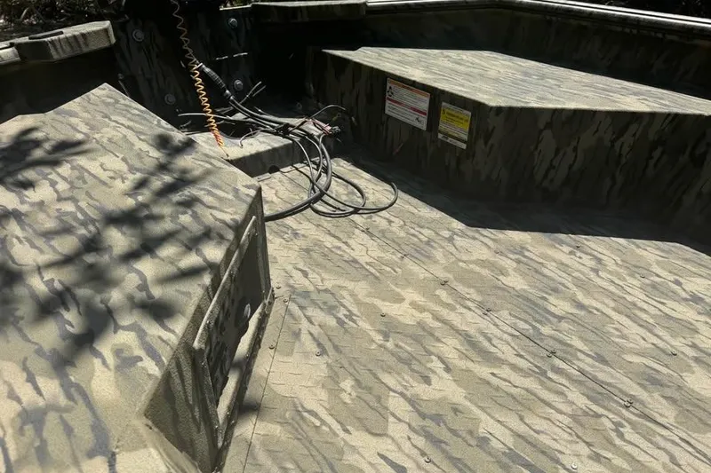 Slide: The Image of 2025 SeaArk 1752 Slayer Pro boat interior with camouflage pattern and wiring details. - 12