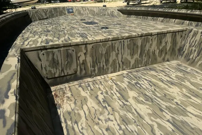 Slide: The Image of 2025 SeaArk 1752 Slayer Pro boat with camouflage interior design. - 16