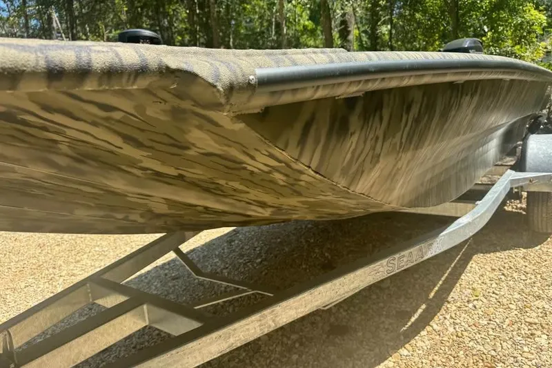 Slide: The Image of 2025 SeaArk 1752 Slayer Pro boat on trailer, showcasing camouflage design and sturdy build. - 3