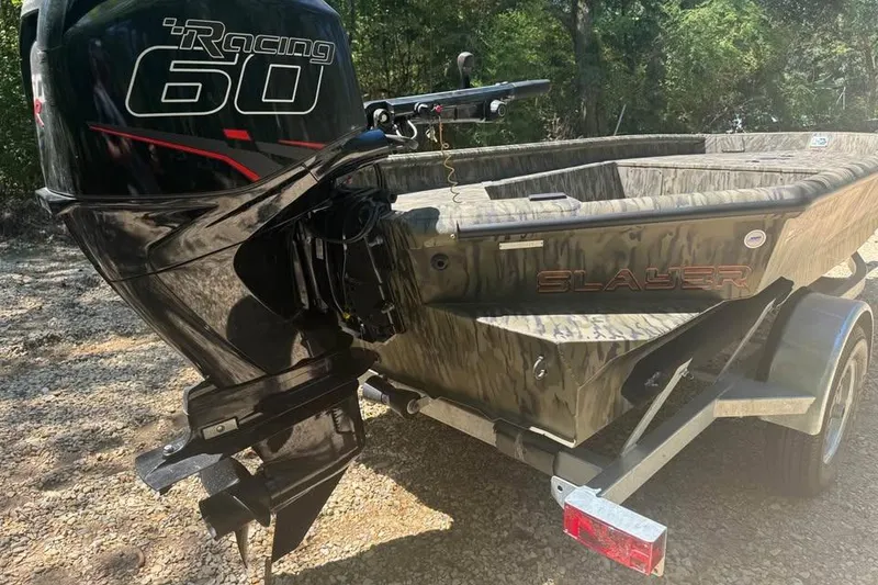 Slide: The Image of 2025 SeaArk 1752 Slayer Pro boat with Racing 60 outboard motor on trailer. - 7