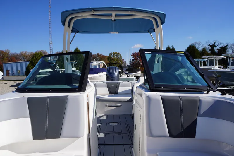 Slide: The Image of 2026 Chaparral 21 SSi OB boat with blue canopy and sleek interior design. - 12