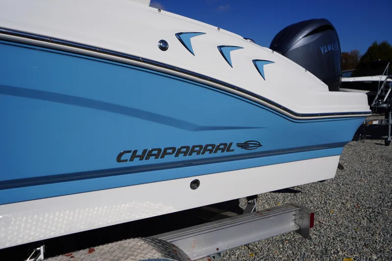 Slide: The Image of 2026 Chaparral 21 SSi OB boat with Yamaha engine, blue and white design. - 2