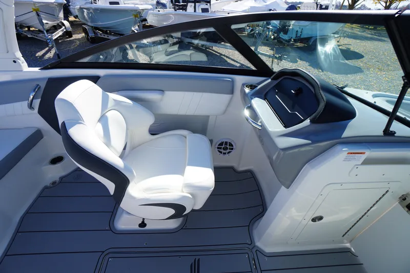 Slide: The Image of 2026 Chaparral 21 SSi OB boat interior with white seating and modern dashboard. - 21