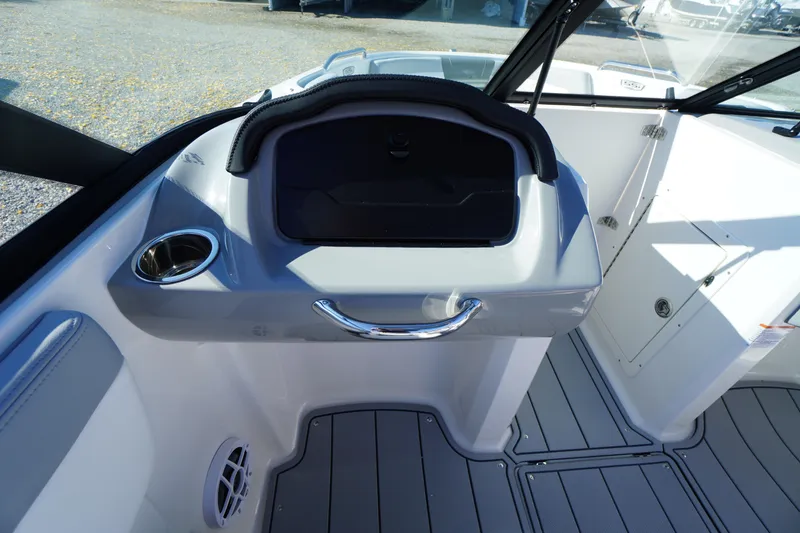 Slide: The Image of Interior of 2026 Chaparral 21 SSi OB boat, featuring sleek dashboard and cup holder. - 22