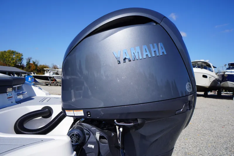 Slide: The Image of 2026 Chaparral 21 SSi OB with Yamaha outboard motor in a marina setting. - 55