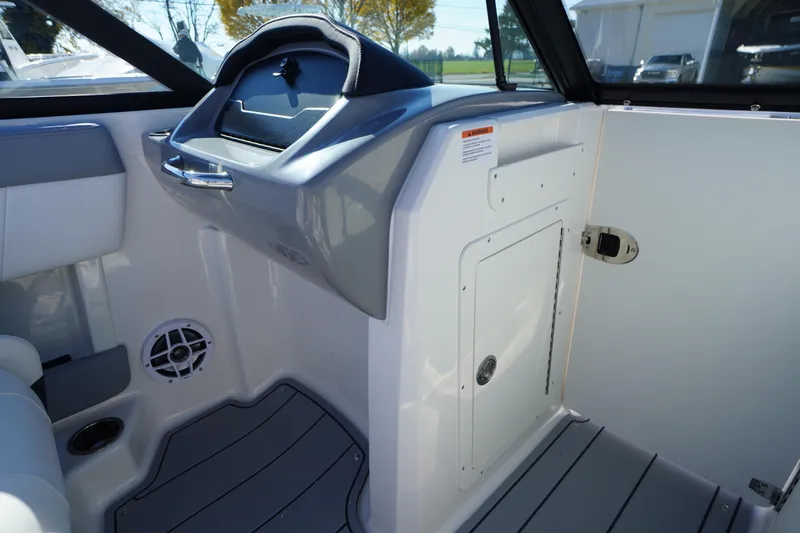 Slide: The Image of Interior of 2026 Chaparral 21 SSi OB boat, featuring sleek design and storage compartment. - 24