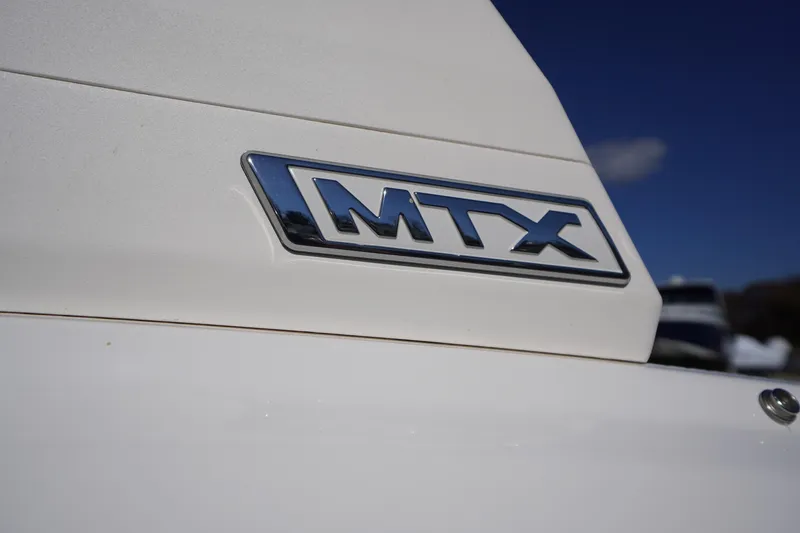 Slide: The Image of 2026 Chaparral 21 SSi OB boat with MTX emblem on white surface. - 28