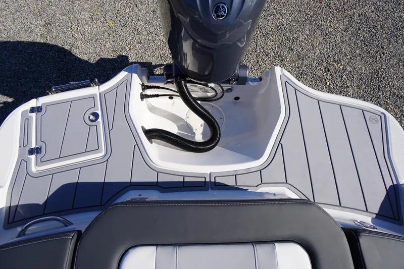 Slide: The Image of 2026 Chaparral 21 SSi OB boat deck with sleek design and modern outboard motor. - 51