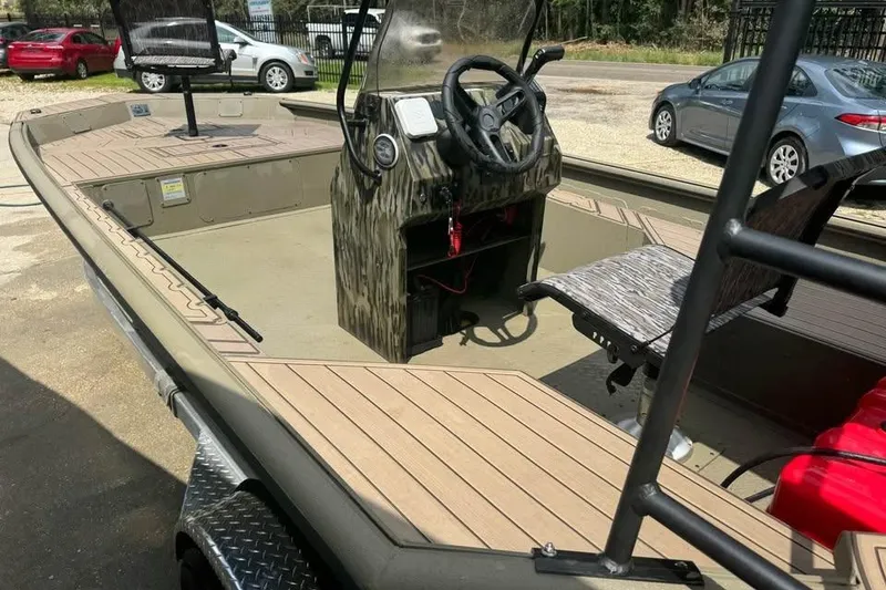 Slide: The Image of 2025 SeaArk Slayer Pro boat interior with steering console and seating. - 11