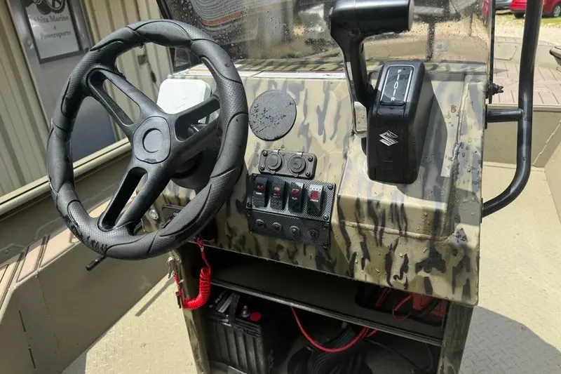 Slide: The Image of 2025 SeaArk Slayer Pro boat console with steering wheel and controls. - 12